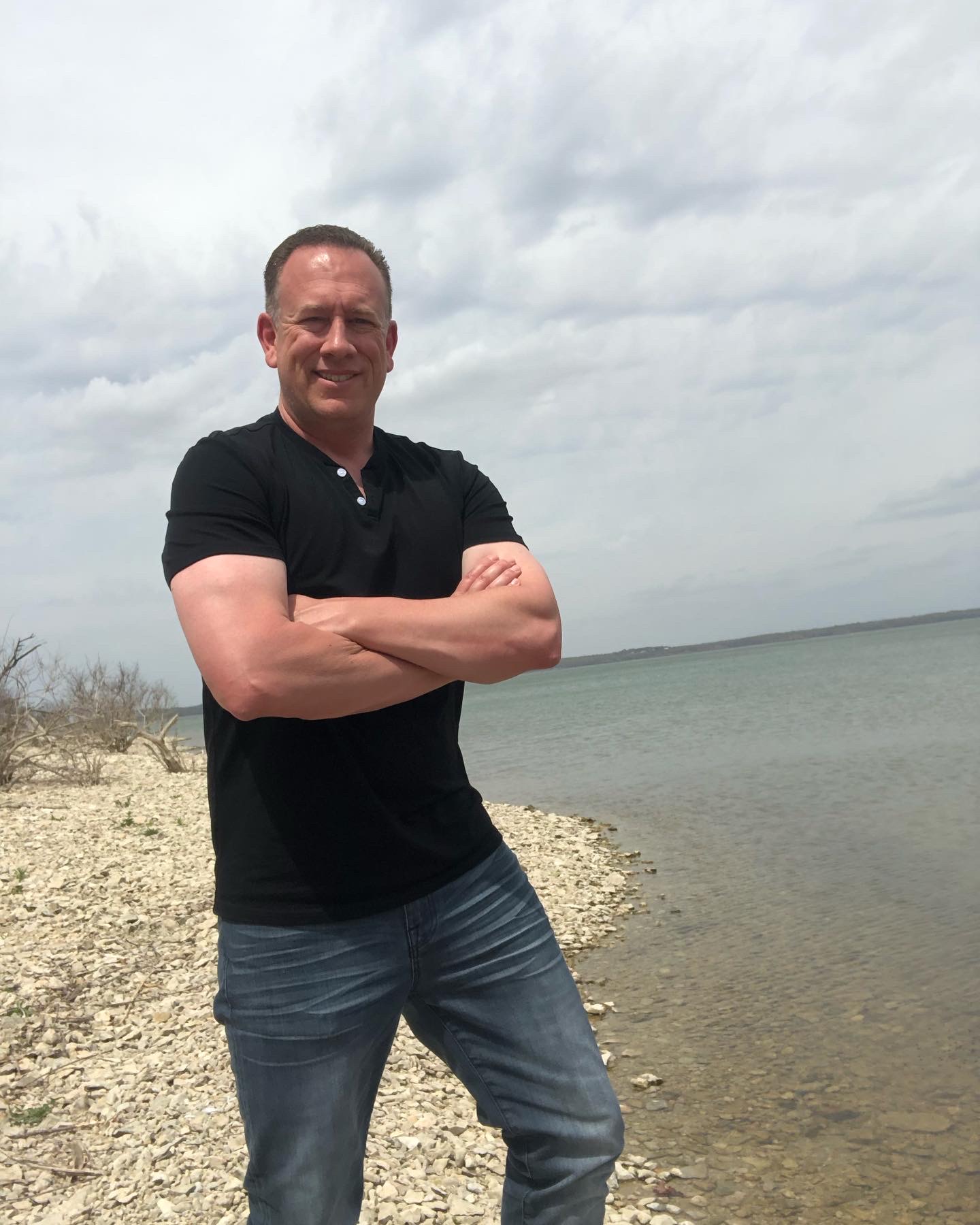 Terry Larkin standing beside a lake on a quiet outdoor day.